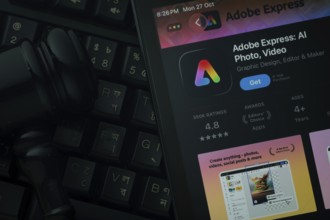 Dhaka, Bangladesh- 28 Oct 2025: An iPad displaying the Adobe Express app against a judge's gavel