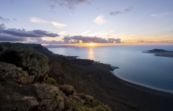View from steep cliffs to sea and coast with sun stars, Mirador del Porrito viewpoint at sunset,