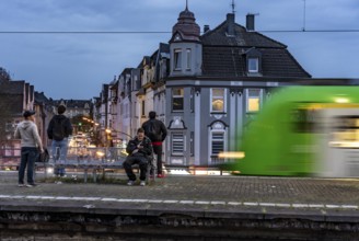 Essen-Steele S-Bahn station, passengers waiting for the train late afternoon, in autumn, Essen,