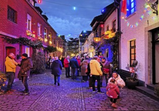 People in the Tiefstraße decorated for the Martin train in the evening, historic old town, Kempen,