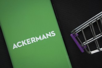 Dhaka, Bangladesh- 03 July 2025: A smartphone displaying the Ackermans logo next to a miniature