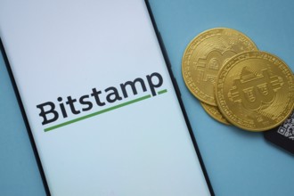 Dhaka, Bangladesh- 03 Sep 2025: Bitstamp logo on smartphone screen near Bitcoin coin and QR code on