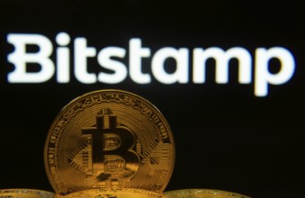 Dhaka, Bangladesh- 03 Sep 2025: Close-up of Bitcoin coins with the Bitstamp logo visible on a