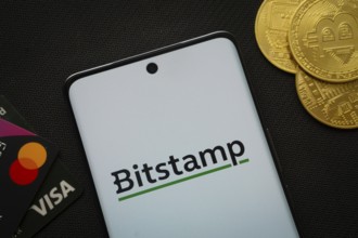 Dhaka, Bangladesh- 06 Sep 2025: Smartphone displaying Bitstamp logo surrounded by Bitcoin coins and