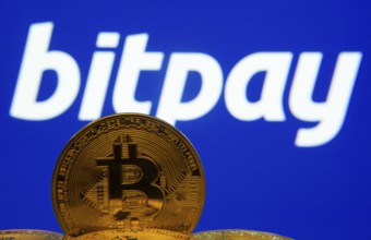 Dhaka, Bangladesh- 26 Aug 2025: Close-up of Bitcoin coins with the bitpay logo visible on a screen