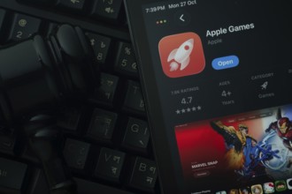 Dhaka, Bangladesh- 28 Oct 2025: An iPad displaying the Apple Games app against a judge's gavel and