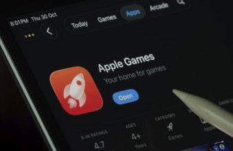 Dhaka, Bangladesh- 30 Oct 2025: Apple Games app displayed on a iPad screen in dark mode with a