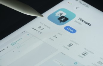 Dhaka, Bangladesh- 30 Oct 2025: Apple Translate app on a iPad screen with a pen pointing at the