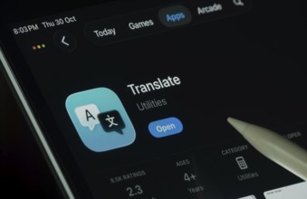 Dhaka, Bangladesh- 30 Oct 2025: Apple Translate app displayed on a iPad screen in dark mode with a