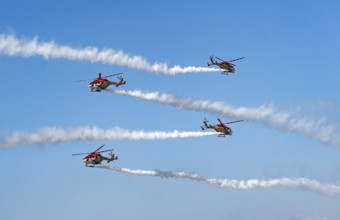 Indian Air Force (IAF) ALH Mk1 Sarang helicopters soar through the sky during an air show as part