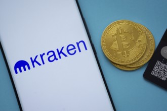 Dhaka, Bangladesh- 26 Aug 2025: Smartphone displaying Kraken logo surrounded by Bitcoin coins and