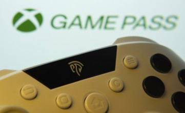 Dhaka, Bangladesh- 01 Nov 2025: A close-up of a gamepad with the Xbox Game Pass seen on screen in