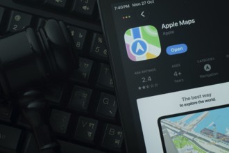 Dhaka, Bangladesh- 28 Oct 2025: An iPad displaying the Apple Maps app against a judge's gavel and