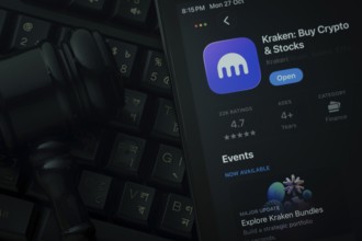 Dhaka, Bangladesh- 28 Oct 2025: An iPad displaying the Kraken app against a judge's gavel and dark