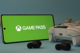 Dhaka, Bangladesh- 15 July 2025: A smartphone with a Xbox Game Pass icon next to a controller and