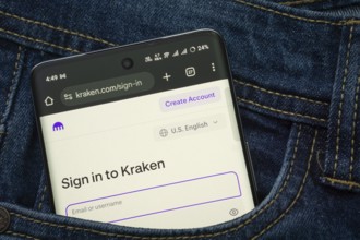 Dhaka, Bangladesh- 15 June 2025: A smartphone displaying the Kraken.com web interface peeks out of