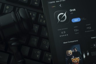 Dhaka, Bangladesh- 28 Oct 2025: An iPad displaying the Grok Ai app against a judge's gavel and dark