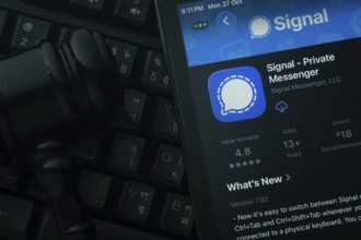 Dhaka, Bangladesh- 28 Oct 2025: An iPad displaying the Signal app against a judge's gavel and dark