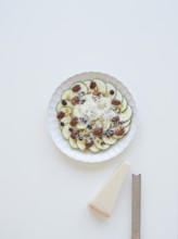 Delicious zucchini carpaccio with parmesan cheese, pecan nuts, raisins and cranberries served on