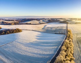 Bird Eye Perspective of Frost Covered Farmland. Seasonal Agricultural Scenery, winter and autumn