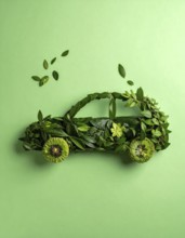 Car formed by green leaves and branches. Sustainable Car technology, ecology concept in harmony
