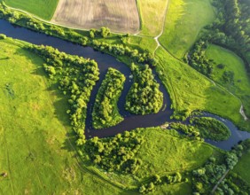 Ecology and environment concept. Green wilderness nature from above. Aerial view on meandering