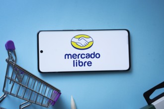 Dhaka, Bangladesh- 03 July 2025: Smartphone displaying Mercado Libre logo with shopping cart on a