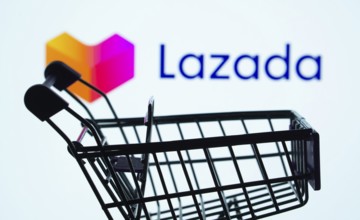 Dhaka, Bangladesh- 03 July 2025: Silhouette of a shopping cart in front of the Lazada logo,