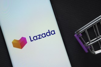 Dhaka, Bangladesh- 03 July 2025: A smartphone displaying the Lazada logo next to a miniature