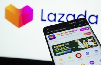 Dhaka, Bangladesh- 03 July 2025: Smartphone displaying Lazada web interface against Lazada logo