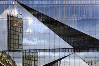 Cube Berlin, cube-shaped office building with folded glass façade reflecting the surroundings,