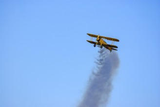 A Boeing-Stearman biplane during a flight demonstration as part of an air show at the Rossfeld in