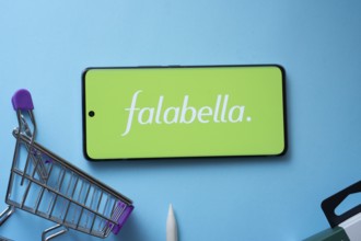 Dhaka, Bangladesh- 03 Oct 2025: Smartphone displaying Falabella. logo with shopping cart on a blue