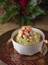 Gourmet lobster risotto with diced vegetables served on a decorative plate