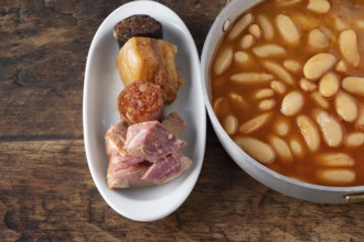 Fabada asturiana, a traditional spanish bean stew with various pork products