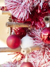 Red and white baubles decorating a festive bamboo christmas tree, celebrating holiday season