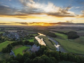 Sunset over Norham Castle and River Tweed from a drone, Norham, Northumberland, England, United