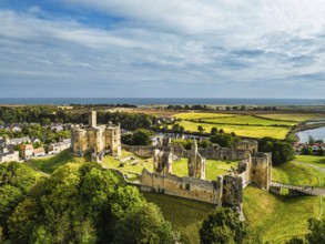 Warkworth Castle over River Coquet from a drone, Warkworth, Northumberland, England, United Kingdom