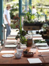 Workshop table with mortars, pestles, brushes, paper and natural pigments, ready for creating inks