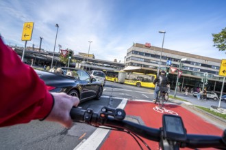 Riding a bike in a bike lane, marked in red to attract the attention of motorists, between 2 lanes,