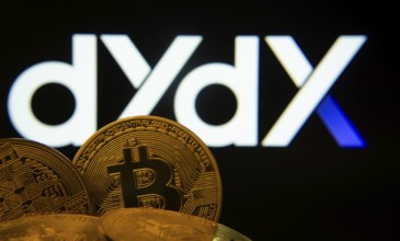 Dhaka, Bangladesh- 03 Oct 2025: Close-up of Bitcoin coins with the Dydx logo visible on a screen in