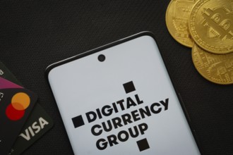 Dhaka, Bangladesh- 03 Oct 2025: Smartphone displaying Digital currency group logo surrounded by