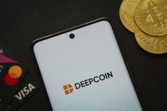Dhaka, Bangladesh- 03 Oct 2025: Smartphone displaying Deepcoin logo surrounded by Bitcoin coins and