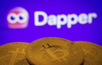 Dhaka, Bangladesh- 03 Oct 2025: Close-up of Bitcoin coins with the Dapper logo visible on a screen