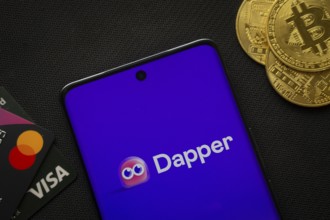 Dhaka, Bangladesh- 03 Oct 2025: Smartphone displaying Dapper logo surrounded by Bitcoin coins and