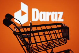 Dhaka, Bangladesh- 03 Oct 2025: Silhouette of a shopping cart in front of the Daraz logo,