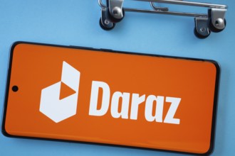 Dhaka, Bangladesh- 03 Oct 2025: Smartphone screen showing the Daraz logo with shopping cart wheels