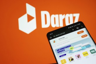 Dhaka, Bangladesh- 03 Oct 2025: Smartphone displaying Daraz web interface against Daraz logo