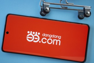 Dhaka, Bangladesh- 03 Oct 2025: Smartphone screen showing the Dangdang.com logo with shopping cart
