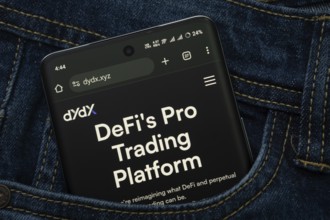 Dhaka, Bangladesh- 03 Oct 2025: A smartphone displaying the Dydx web interface peeks out of a denim